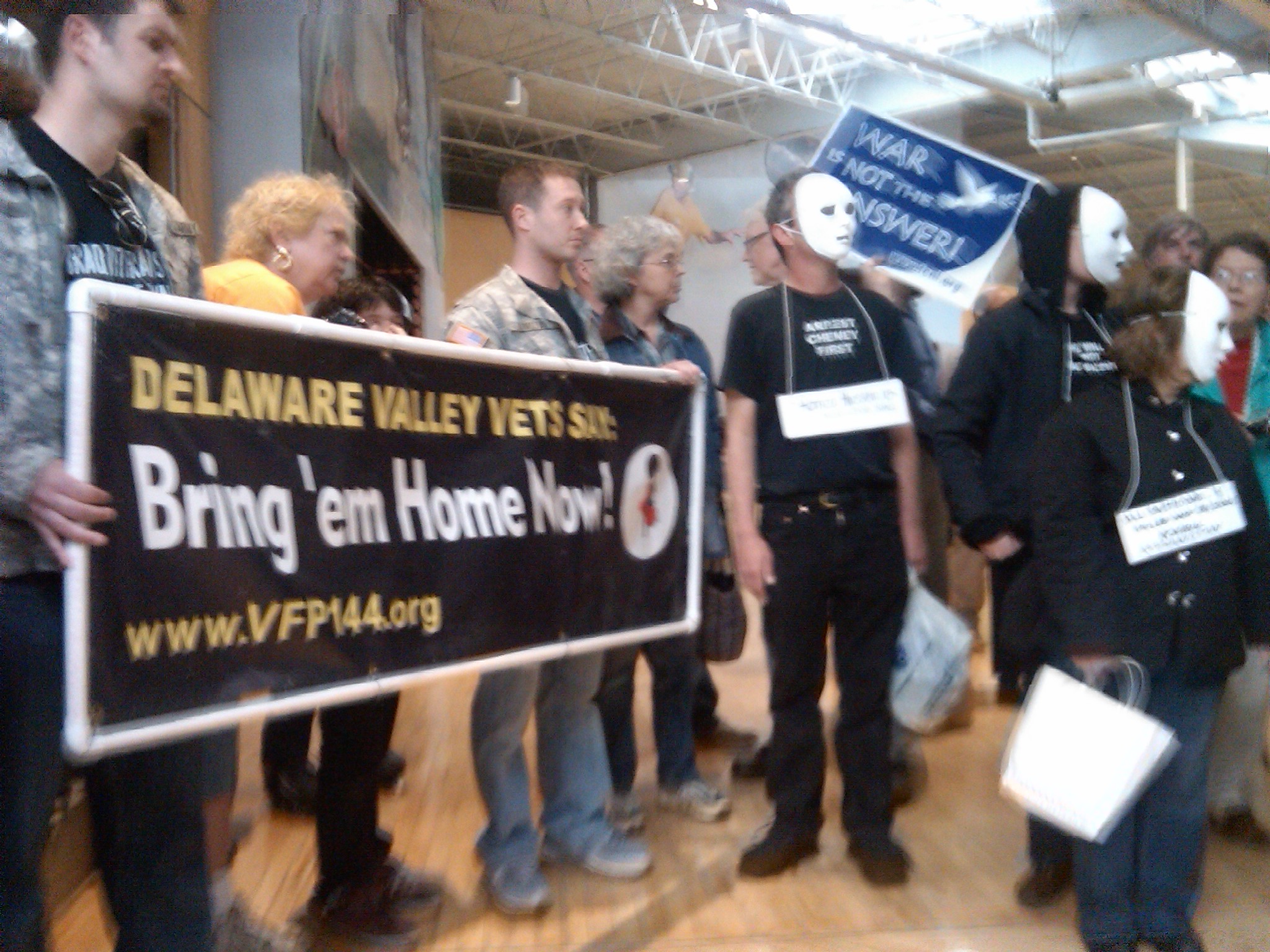 Photographer:  Copyright 2009, Paul Kawika Martin. Nearly 300 veterans (Iraq vet, Sgt. Jesse Hamilton shown on left) military families and peace activists shut down what they called the unethical teenage recruitment at the “Army Experience Center.”  Seven were arrested for refusing to leave.  Peace Action and its affiliates help organize the protest.