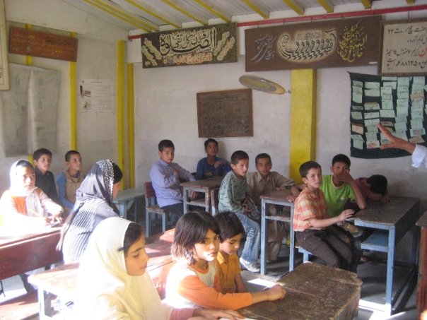 The delegation passes through a schoolhouse